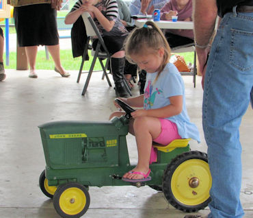 Photo of a little girl on a tractor